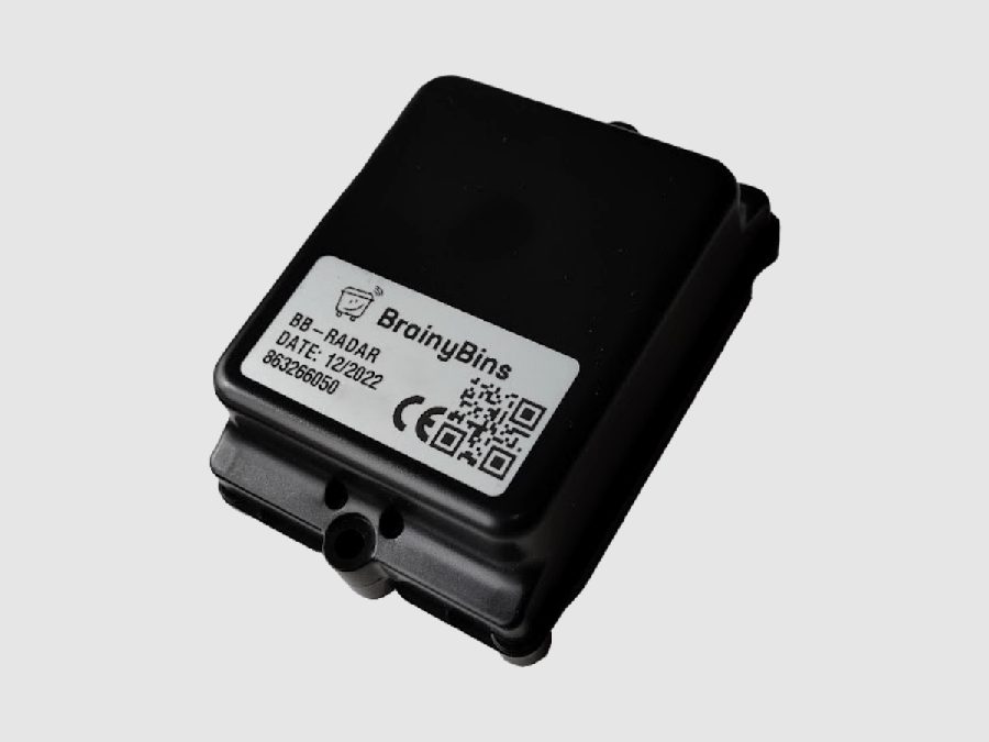 A sealed black radar fill-level sensor unit, roughly the size of a matchbox, with a CE-marked label